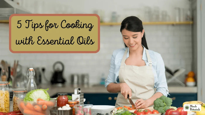 Smiling woman in an apron chopping vegetables in a kitchen, with text: 5 Tips for Cooking with Essential Oils