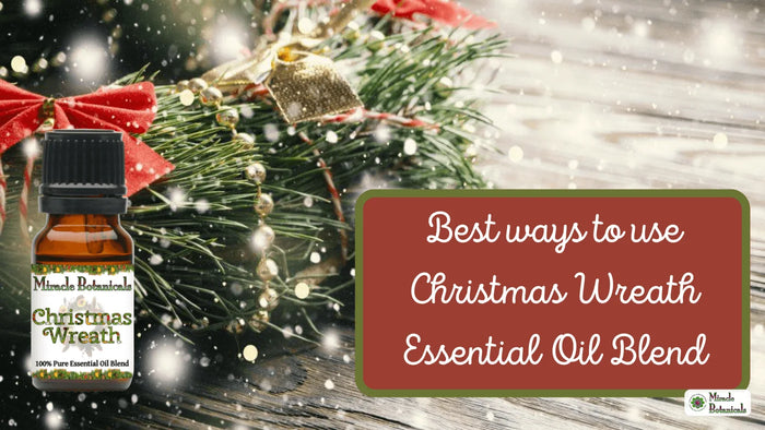Christmas Wreath essential oil blend bottle by snowy evergreen boughs and a red bow, with text: Best ways to use Christmas Wreath