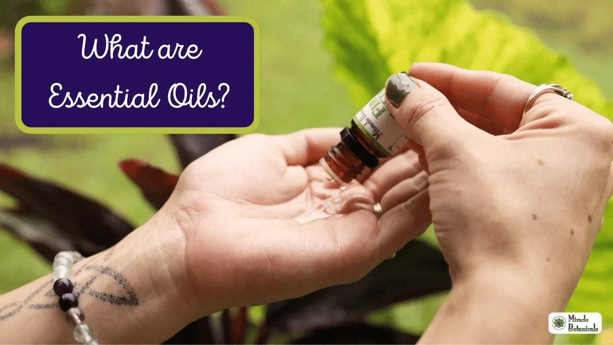 Hands dropping essential oil from an amber bottle into an open palm, with text: What are Essential Oils?