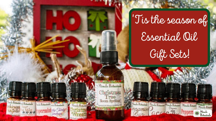 Christmas Tree Room Spritzer and gift-set bottles like Christmas Wreath and Peppermint, with text: 'Tis the season of Essential Oil Gift Sets!