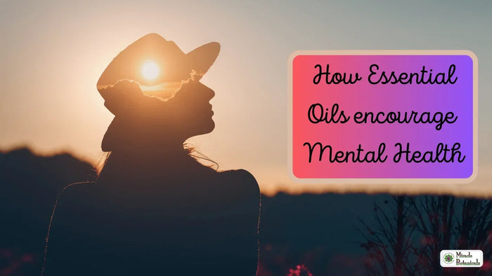 Silhouette of a woman in a cap against the setting sun, with text: How Essential Oils encourage Mental Health
