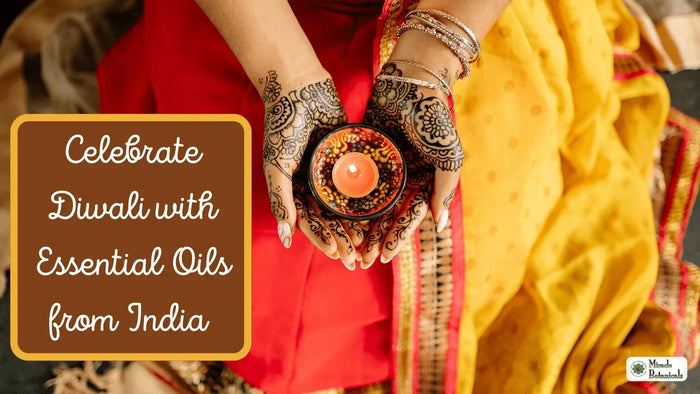 Henna-painted hands holding a lit candle over a red and yellow sari, with text: Celebrate Diwali with Essential Oils from India