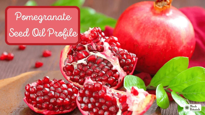 Halved pomegranate with juicy red seeds and green leaves, with text: Pomegranate Seed Oil Profile